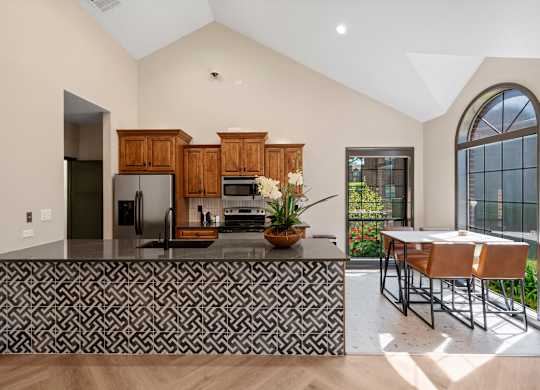 A kitchen with a black and white patterned bar.