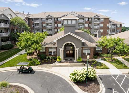 Elevated view of The Claremont Apartments clubhouse and leasing office surrounded by landscaped grounds and residential buildings in Overland Park, KS.