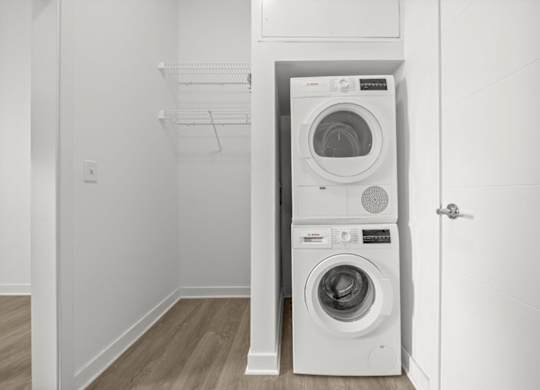 A white washing machine and dryer in a small laundry room.