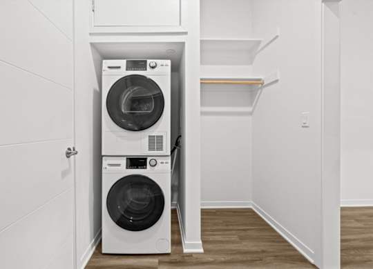A white washing machine and dryer in a small laundry room.