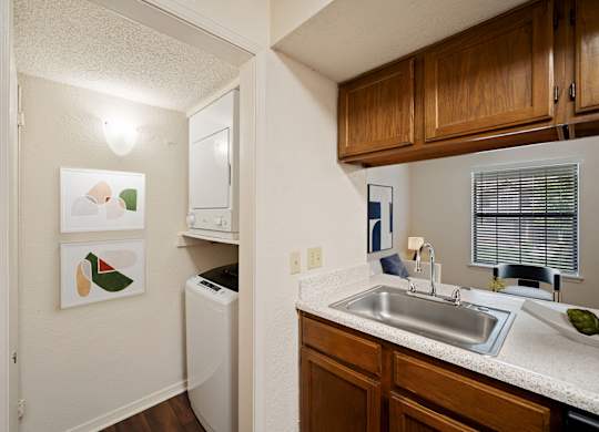 A small kitchen with a white dishwasher and a white sink.