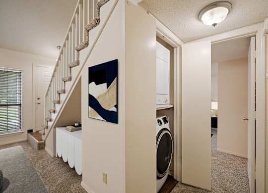 A laundry room with a washer and dryer in it.