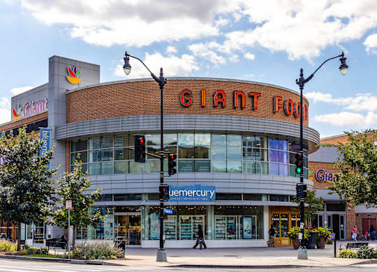 a large building with a giant corn sign on top of it on a city street