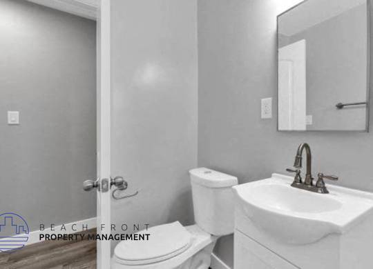 a bathroom with a toilet and a sink and a mirror
