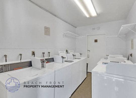 an image of a laundry room with sinks and washing machines