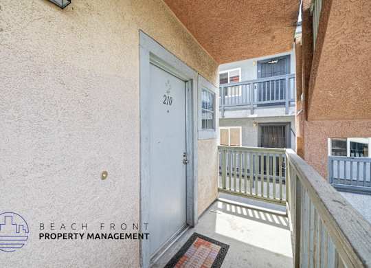 A balcony with a door numbered 210 is shown.