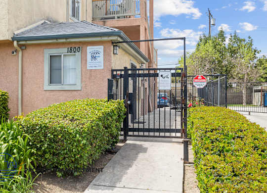 A building with the number 1800 on it is surrounded by a black gate.