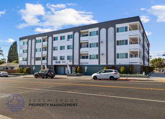 A building with the words Beach Front Property Management on the bottom left corner.