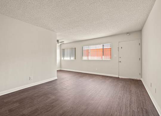 A room with wooden floors and white walls.