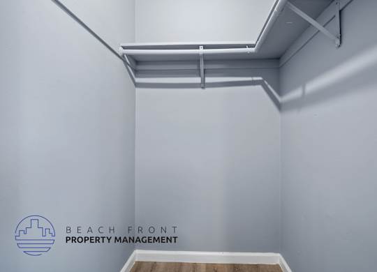 A white wall with a logo that says Beach Front Property Management.
