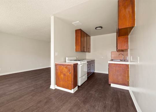 A kitchen with white appliances and wooden cabinets.