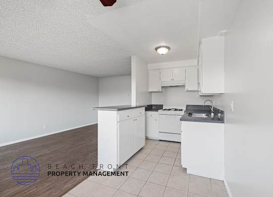 a white kitchen with white cabinets and white appliances