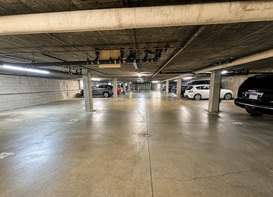 A parking garage with concrete floors and pillars.