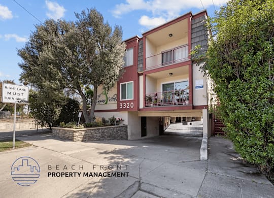 A two-story building with a balcony and a sign that says