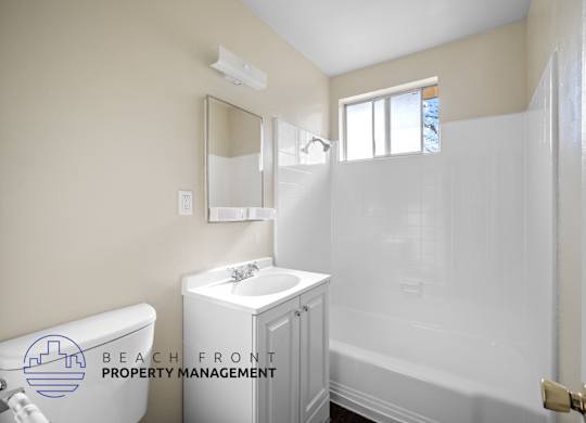 a white bathroom with a white sink and shower and a white tub