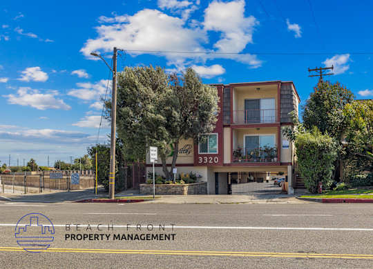 A two-story building with a balcony is located on Beach Front property.