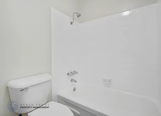 A white toilet and sink in a bathroom.