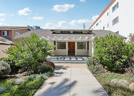 A house with a front yard and a driveway.