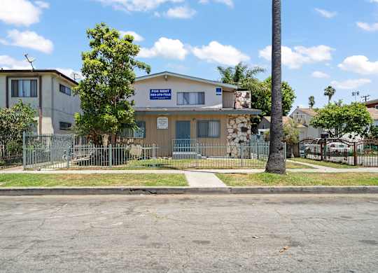 A building with a blue sign in front of it.