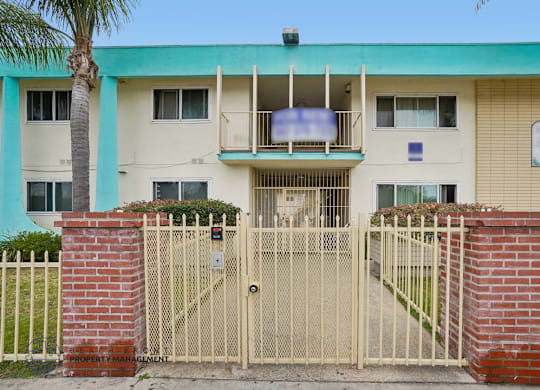 A building with a gate and a sign that says