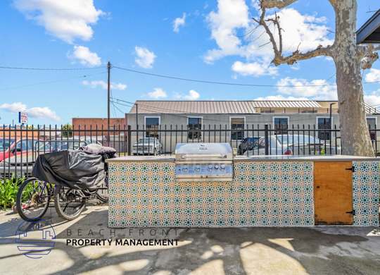 a barbecue grill with a bike parked in front of a building