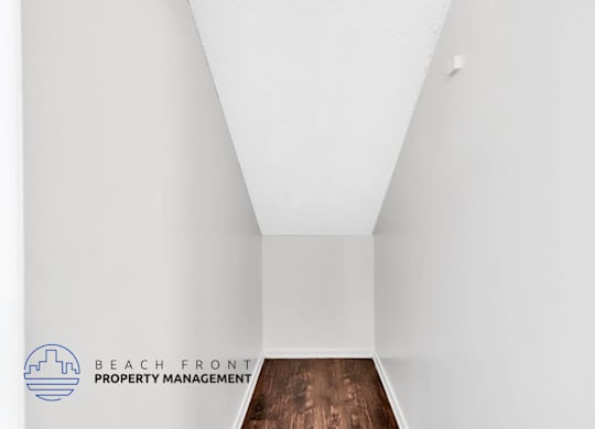 A logo for Beach Front Property Management is on a white wall.