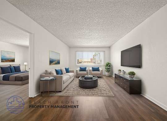 A living room with a flat screen TV mounted on the wall.