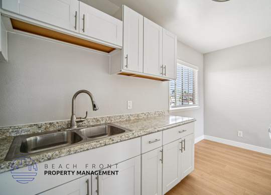 A kitchen with a sink and cabinets.