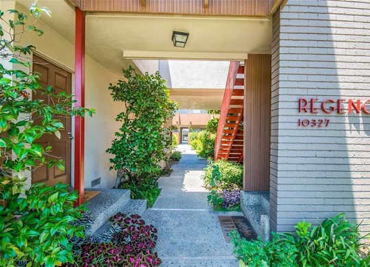 A building with a red door and a sign that says