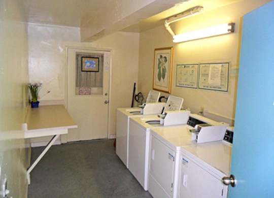 A small room with a desk and a cabinet.
