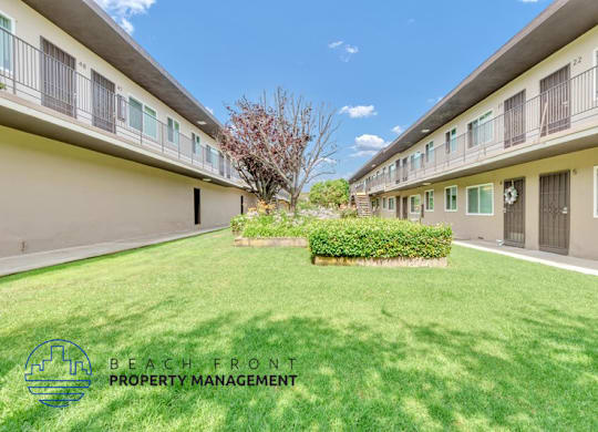 a large green lawn in the backyard of a building