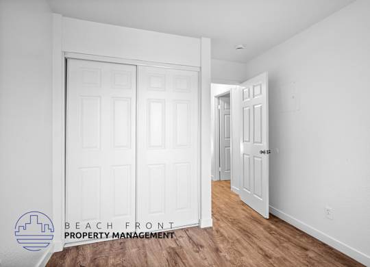 a bedroom with two closets and a door to a hallway