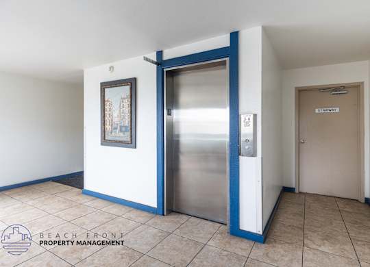 A hallway with a blue door and a sign that says