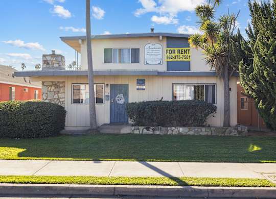 A house with a for rent sign on the front.
