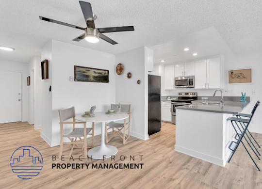 a living room and kitchen with a table and chairs and a ceiling fan
