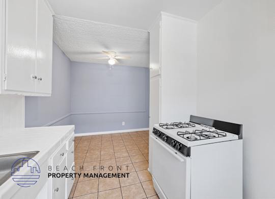 A kitchen with a stove and cabinets.