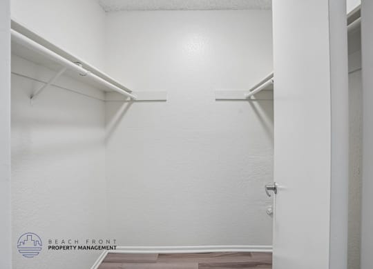 A white hallway with a door on the right and a wall on the left.