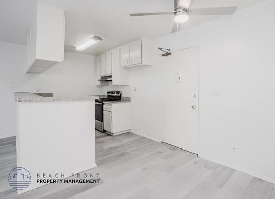 A kitchen area with a stove, oven, and cabinets.