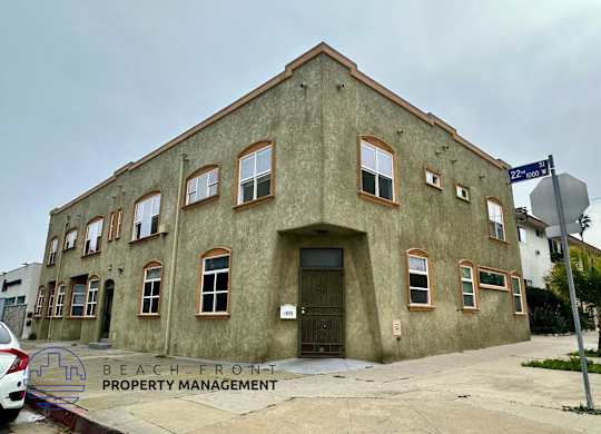 A building with a sign that says Beach Front Property Management.