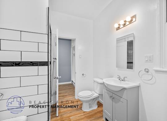 a bathroom with a toilet and a sink and a shower