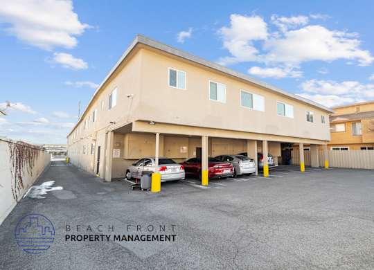 A parking lot with cars and a building with the sign
