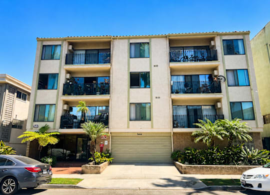 A modern apartment building with a clear blue sky above.