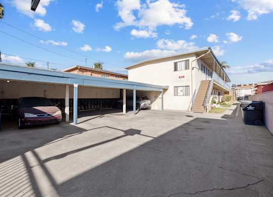A parking garage with a car parked in front of it.