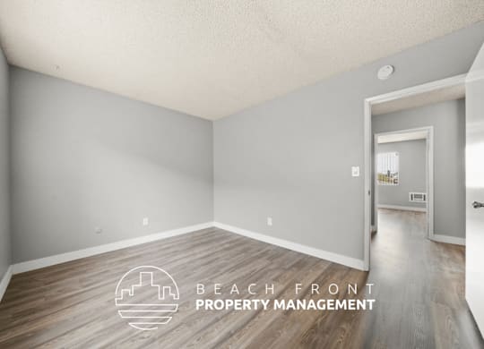 A room with a logo of Beach Front Property Management on the floor.