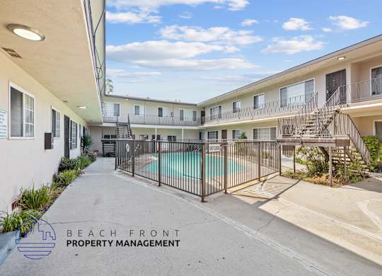 A pool area of a building with a sign that says
