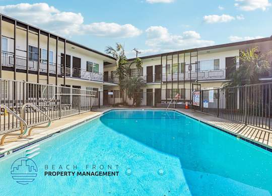 A pool in a courtyard surrounded by a fence.