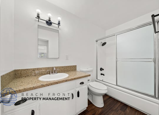 view of a large bathroom with shower and cabinets