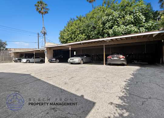 a parking lot with cars parked in front of a building