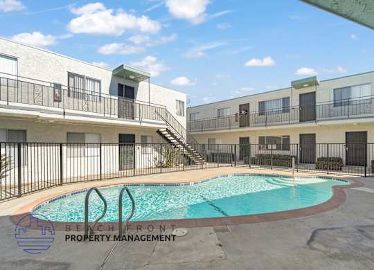 A pool with a logo that says Beach Front Property Management.