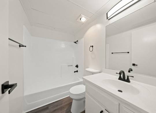 a white bathroom with a sink and a toilet